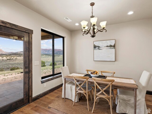dining room featuring recessed lighting, baseboards, a chandelier, visible vents, and wood finished floors
