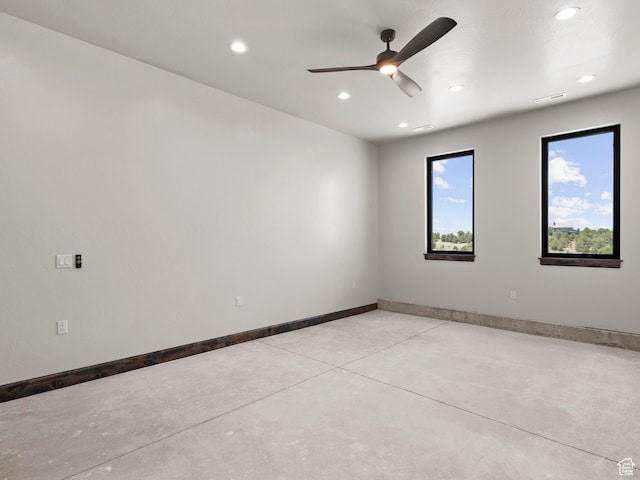 spare room featuring finished concrete floors, baseboards, visible vents, ceiling fan, and recessed lighting
