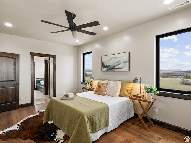 bedroom featuring wood finished floors, baseboards, visible vents, ceiling fan, and recessed lighting