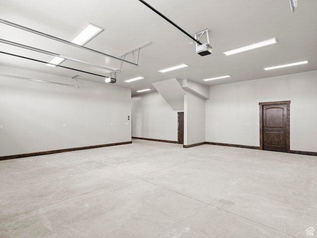 garage with baseboards and a garage door opener