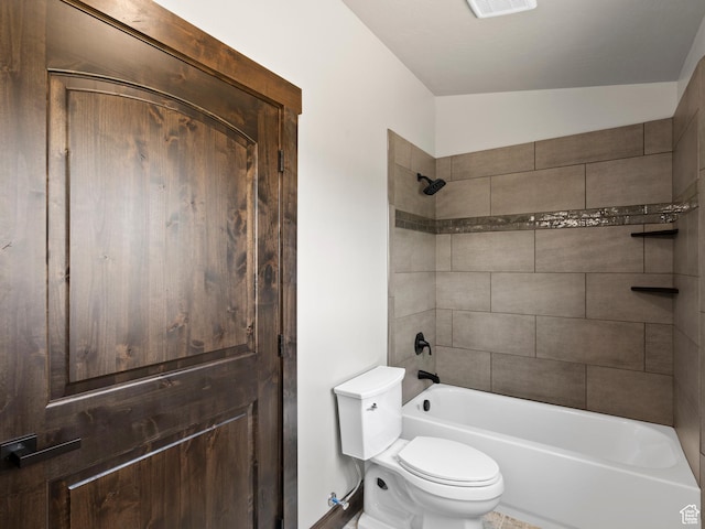 bathroom featuring toilet, bathing tub / shower combination, and visible vents