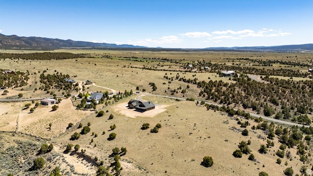 aerial view featuring view of desert, a mountain view, and a rural view