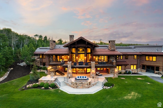 2586 N Whispering Springs Hollow Rd Unit 20, Heber City, UT 84032 - back of property with a chimney, a standing seam roof, a patio, and a lawn