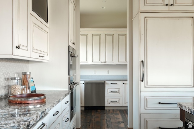 2586 N Whispering Springs Hollow Rd Unit 20, Heber City, UT 84032 - kitchen with appliances with stainless steel finishes, cream cabinetry, dark wood-style floors, decorative backsplash, and light stone countertops
