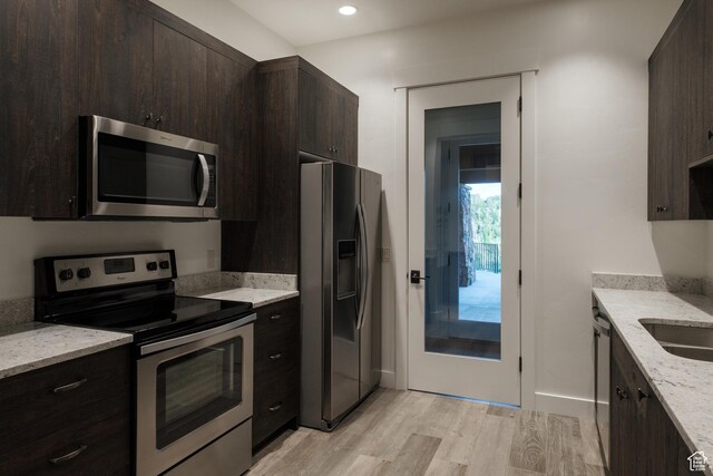 2586 N Whispering Springs Hollow Rd Unit 20, Heber City, UT 84032 - kitchen featuring stainless steel appliances, light wood-style floors, dark brown cabinetry, light stone countertops, and recessed lighting