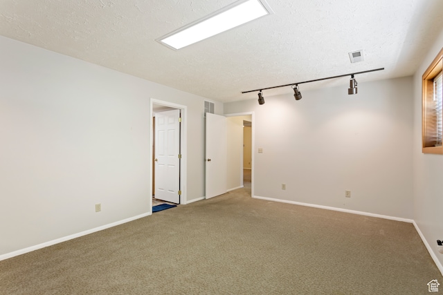 142 S Eccles Ave, Ogden, UT 84404 - unfurnished room featuring a textured ceiling, track lighting, and carpet flooring