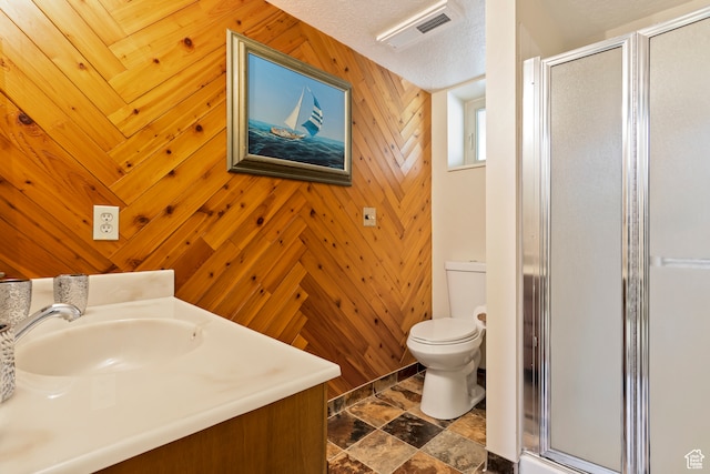 142 S Eccles Ave, Ogden, UT 84404 - bathroom with wood walls, a shower with door, vanity, toilet, and a textured ceiling