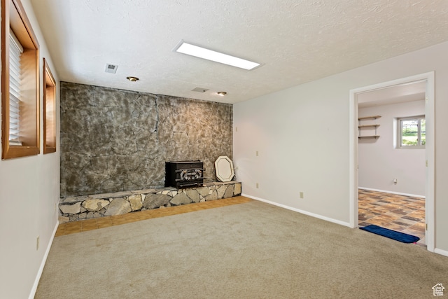 142 S Eccles Ave, Ogden, UT 84404 - unfurnished living room featuring tile flooring, a wood stove, and a textured ceiling
