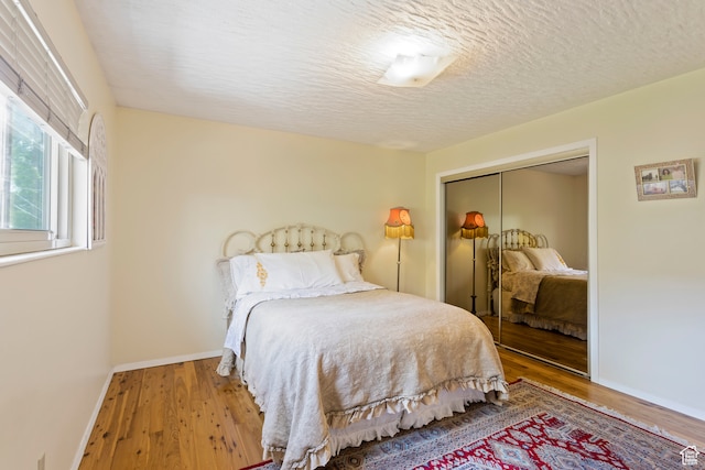 142 S Eccles Ave, Ogden, UT 84404 - bedroom with a closet, a textured ceiling, and hardwood / wood-style flooring