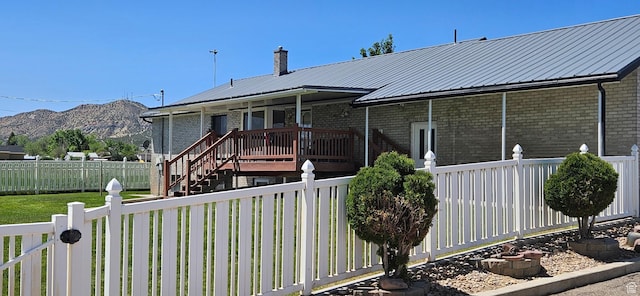 816 N 3500 W, Vernal, UT 84078 - view of front of property featuring brick siding, a metal roof, and a deck with mountain view