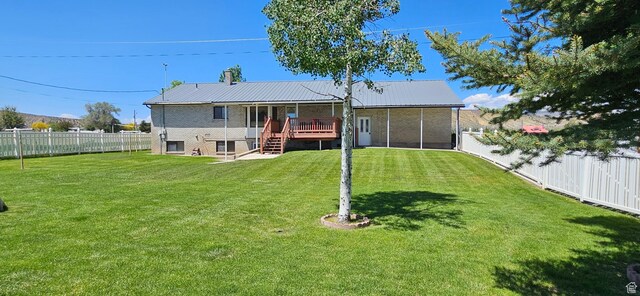 816 N 3500 W, Vernal, UT 84078 - rear view of house with a fenced backyard, stairs, a deck, and a metal roof