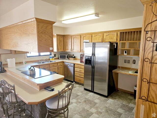 816 N 3500 W, Vernal, UT 84078 - kitchen featuring stainless steel appliances, a peninsula, light countertops, a kitchen bar, and stone finish flooring