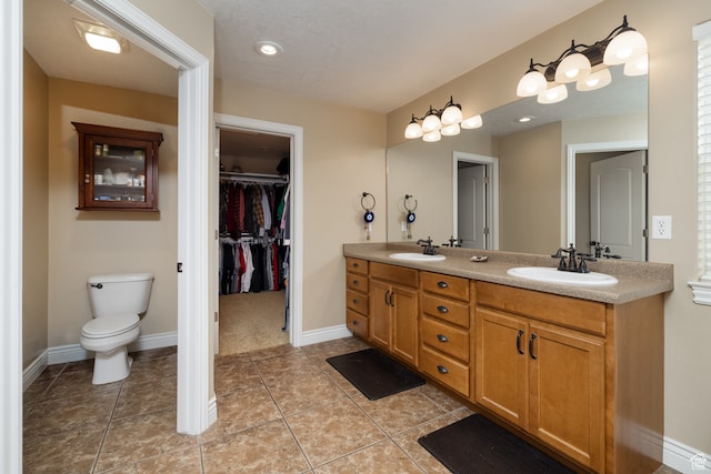 2120 N 2500 W, Vernal, UT 84078 - bathroom with dual sinks, tile flooring, vanity with extensive cabinet space, and toilet
