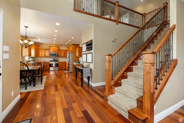 2120 N 2500 W, Vernal, UT 84078 - interior space with a notable chandelier, a towering ceiling, and dark wood-type flooring