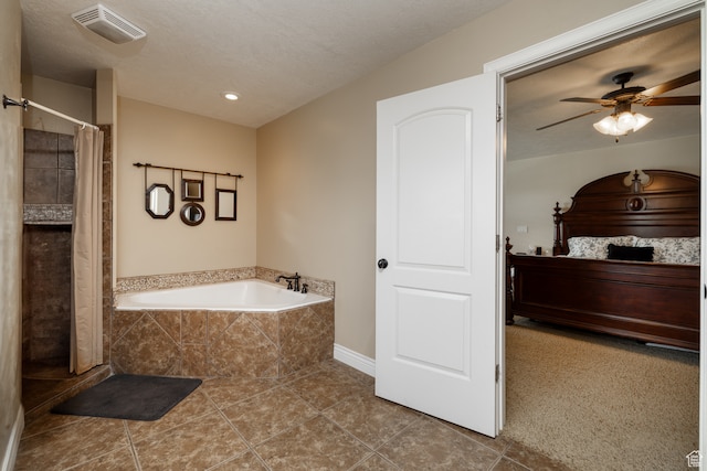 2120 N 2500 W, Vernal, UT 84078 - bathroom with tile floors, a relaxing tiled bath, ceiling fan, and a textured ceiling