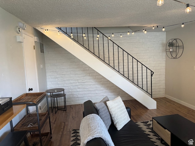 4352 S 1145 W Unit 44C, Salt Lake City, UT 84123 - living room with dark hardwood / wood-style floors, a textured ceiling, and brick wall
