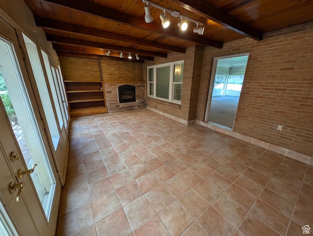 1235 E 820 N, Provo, UT 84606 - unfurnished living room with wood ceiling, brick wall, track lighting, and beamed ceiling