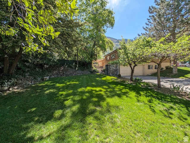 1235 E 820 N, Provo, UT 84606 - view of yard with a mountain view, driveway, and an attached garage