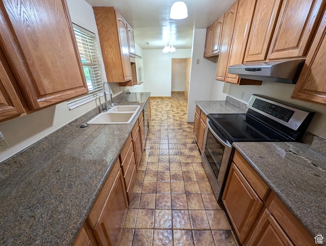 1235 E 820 N, Provo, UT 84606 - kitchen featuring dark stone counters, a sink, stainless steel range with electric stovetop, under cabinet range hood, and brown cabinetry