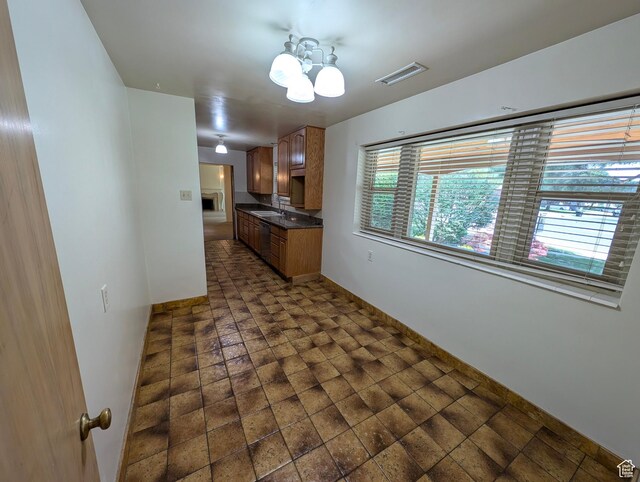1235 E 820 N, Provo, UT 84606 - kitchen with an inviting chandelier, dark countertops, a sink, baseboards, and visible vents