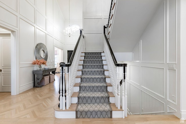 4250 S Camille St, Holladay, UT 84124 - stairway featuring a high ceiling, parquet flooring, and an inviting chandelier
