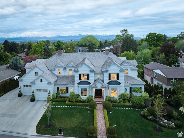 4250 S Camille St, Holladay, UT 84124 - view of front facade with a mountain view, a garage, and a front lawn