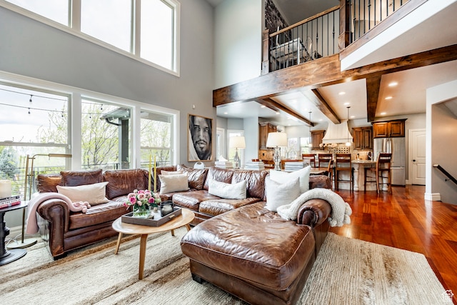 living room featuring a high ceiling and hardwood / wood-style flooring