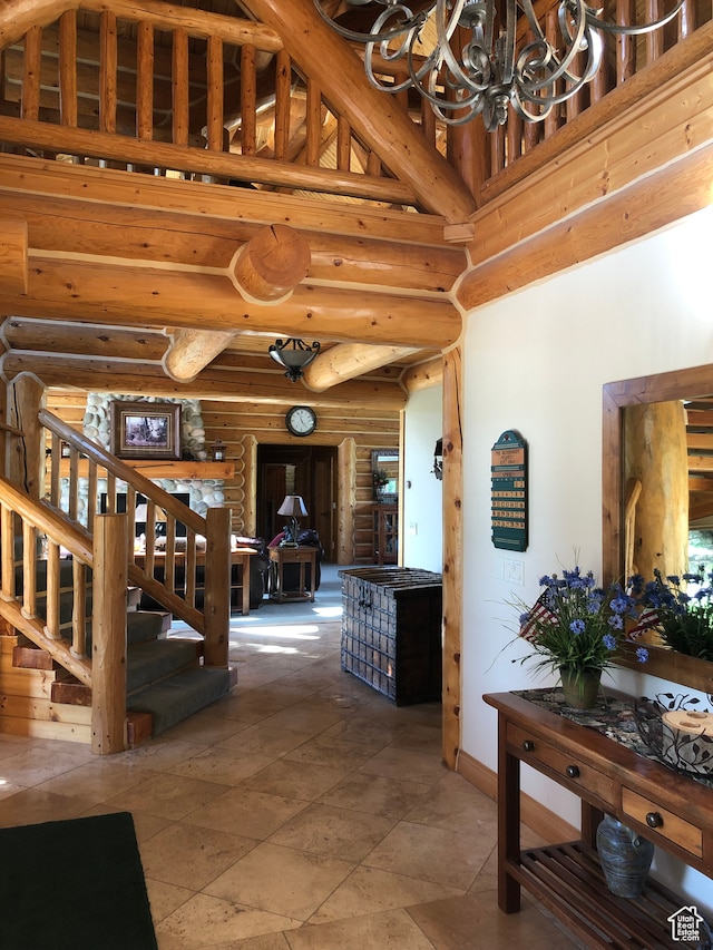 5650 N Franson Ln, Oakley, UT 84055 - interior space with a high ceiling, a chandelier, log walls, and tile floors