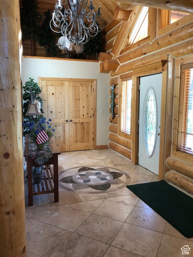 5650 N Franson Ln, Oakley, UT 84055 - entrance foyer with tile flooring, a healthy amount of sunlight, rustic walls, and an inviting chandelier