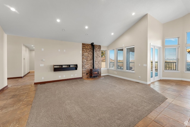 885 S Southflat Rd, Huntington, UT 84528 - unfurnished living room with brick wall, high vaulted ceiling, a wood stove, and light tile floors