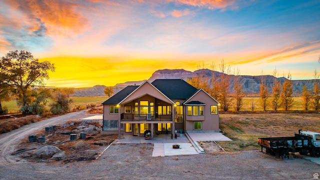 885 S Southflat Rd, Huntington, UT 84528 - back house at dusk with a mountain view and a balcony