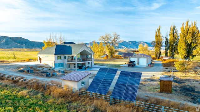885 S Southflat Rd, Huntington, UT 84528 - exterior space featuring solar panels, a mountain view, an outdoor structure, a garage, and a balcony
