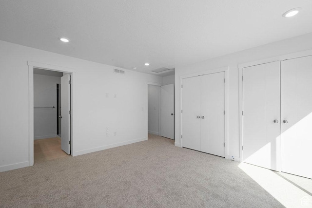 4126 S Winder Ward Dr Unit 2-123, Millcreek, UT 84124 - unfurnished bedroom featuring light carpet, recessed lighting, two closets, and baseboards