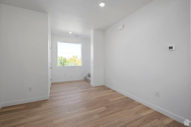 4126 S Winder Ward Dr Unit 2-123, Millcreek, UT 84124 - empty room with light wood-style flooring, stairway, baseboards, recessed lighting, and a textured ceiling