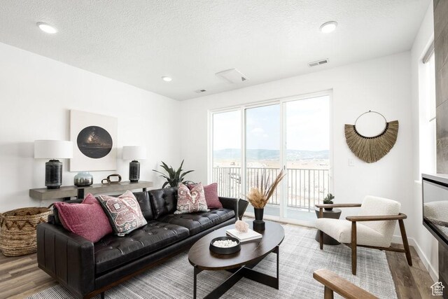 4126 S Winder Ward Dr Unit 2-123, Millcreek, UT 84124 - living area featuring wood finished floors, recessed lighting, a textured ceiling, and baseboards