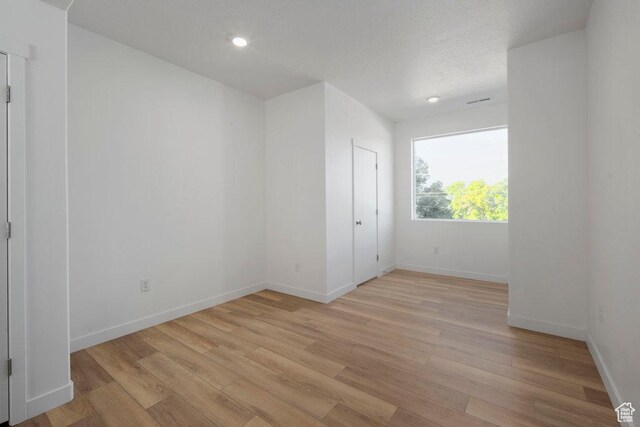 4126 S Winder Ward Dr Unit 2-123, Millcreek, UT 84124 - unfurnished room featuring light wood finished floors, baseboards, and recessed lighting