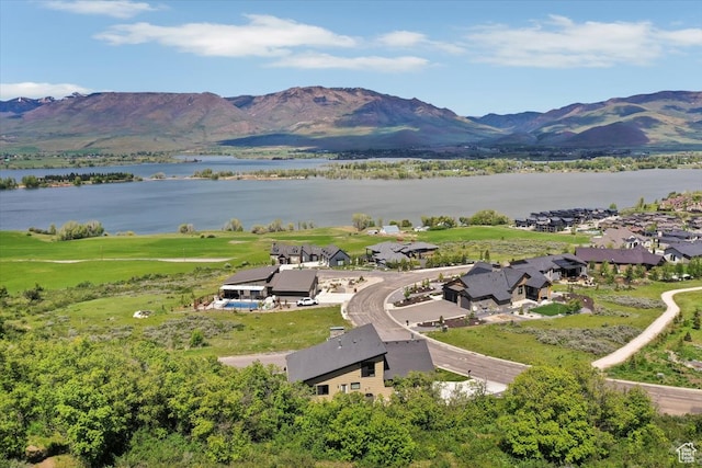drone / aerial view with a water and mountain view