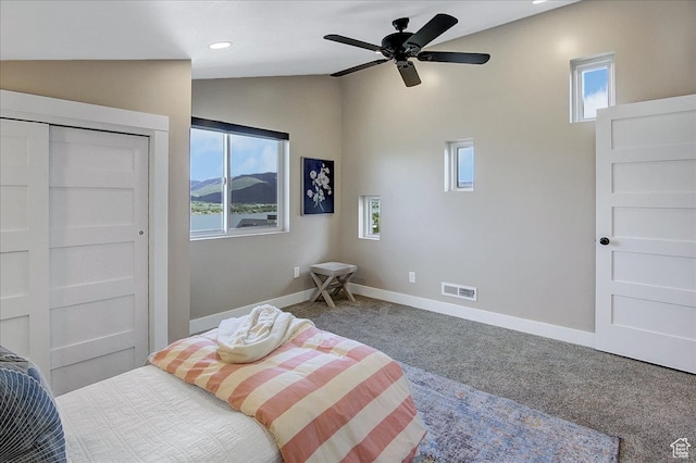 bedroom with carpet flooring, a closet, ceiling fan, and lofted ceiling