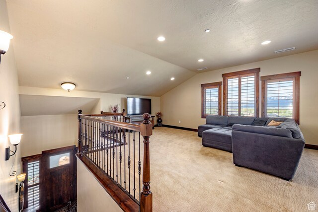 1621 E Abajo Peak Ct, Heber City, UT 84032 - living room featuring a healthy amount of sunlight, a textured ceiling, lofted ceiling, and light colored carpet