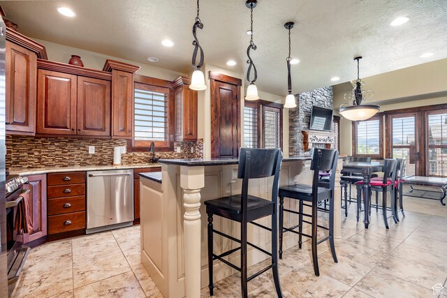 1621 E Abajo Peak Ct, Heber City, UT 84032 - kitchen featuring a kitchen island, backsplash, hanging light fixtures, appliances with stainless steel finishes, and light tile floors