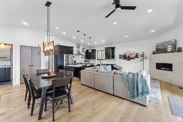 1430 W Arapaho Dr Unit 59, Coalville, UT 84017 - dining space featuring sink, ceiling fan with notable chandelier, vaulted ceiling, and light hardwood / wood-style floors