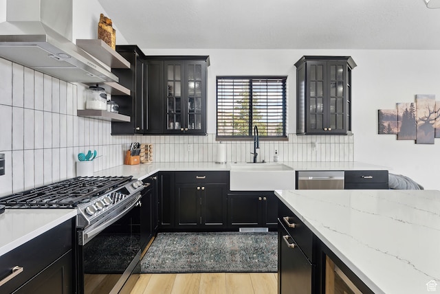 1430 W Arapaho Dr Unit 59, Coalville, UT 84017 - kitchen featuring appliances with stainless steel finishes, range hood, sink, light stone counters, and light hardwood / wood-style flooring