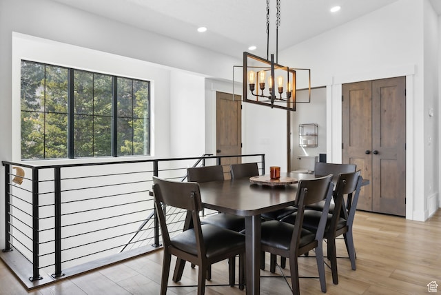1430 W Arapaho Dr Unit 59, Coalville, UT 84017 - dining area with an inviting chandelier, vaulted ceiling, and light wood-type flooring