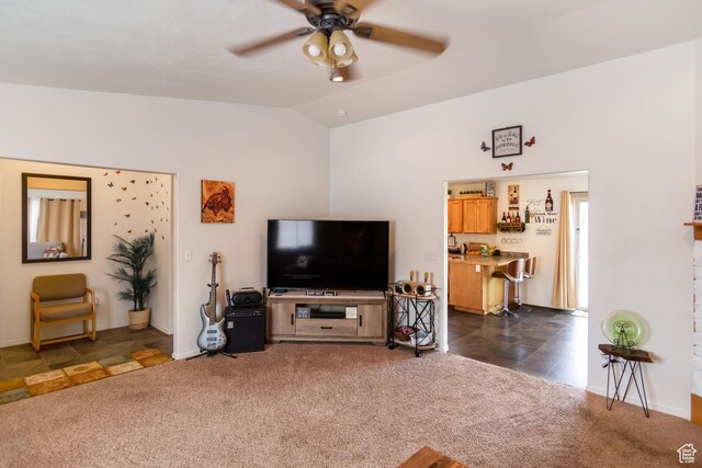 4623 Pueblo Verde Dr, Moab, UT 84532 - living room with dark colored carpet, vaulted ceiling, and ceiling fan