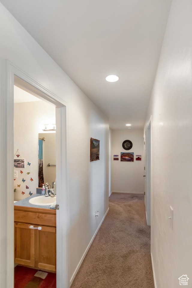 4623 Pueblo Verde Dr, Moab, UT 84532 - hallway with light carpet and sink
