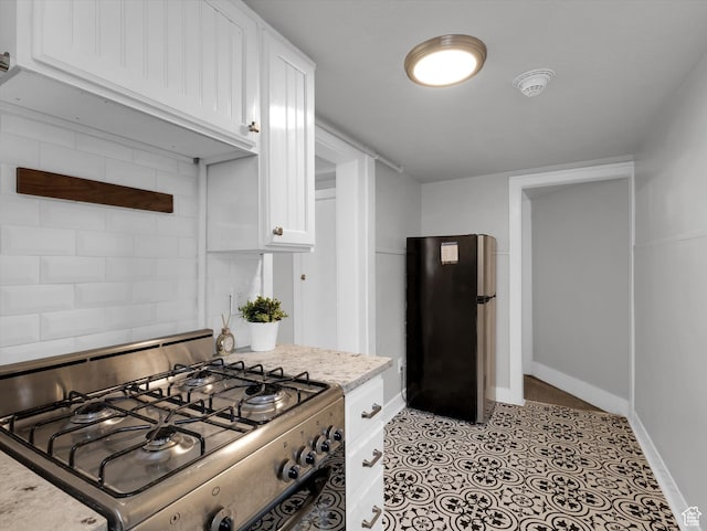 86 B St E Unit 10, Salt Lake City, UT 84103 - kitchen with freestanding refrigerator, gas range, and white cabinets