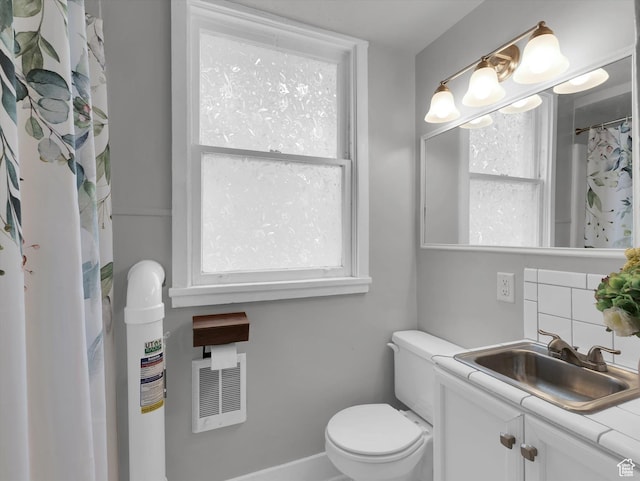 86 B St E Unit 10, Salt Lake City, UT 84103 - bathroom with vanity, tasteful backsplash, and toilet