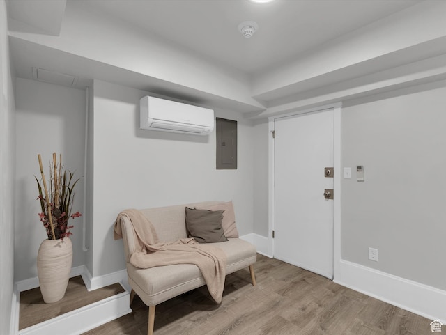 86 B St E Unit 10, Salt Lake City, UT 84103 - sitting room featuring a wall unit AC, electric panel, and light hardwood / wood-style floors