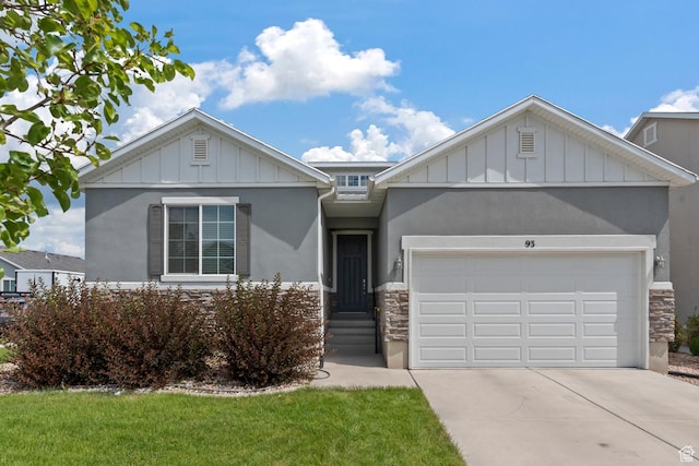 ranch-style house featuring an attached garage, board and batten siding, driveway, and stone siding