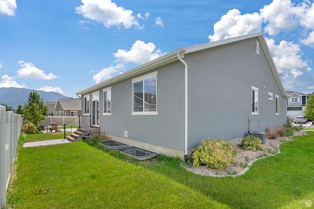 93 E 425 N, Vineyard, UT 84059 - view of side of home featuring a mountain view, fence, and a lawn